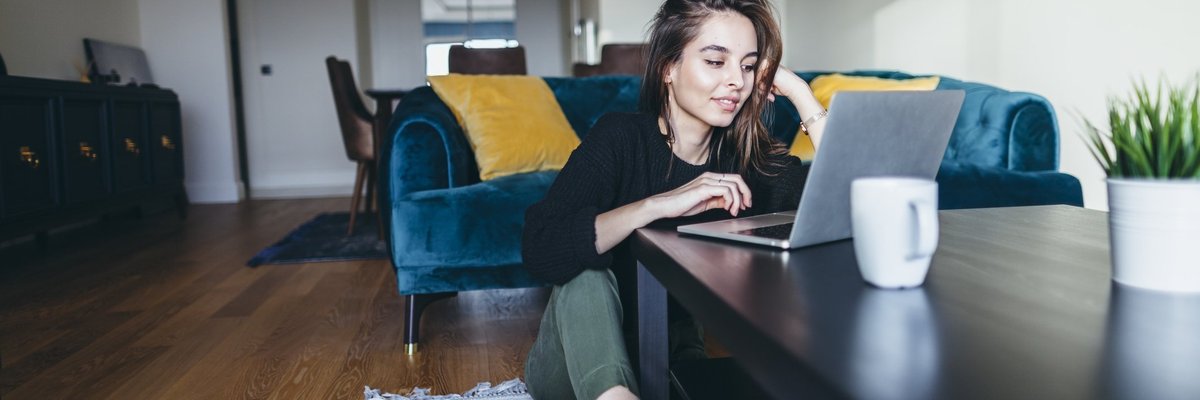 Young Woman Wearing Socks Looking At Her Laptop