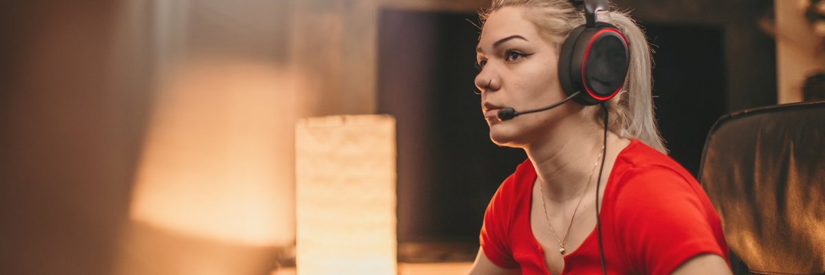 Young adult female engaged in computer gaming.