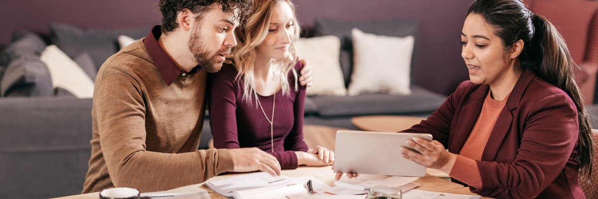 Young couple meets with professional woman.
