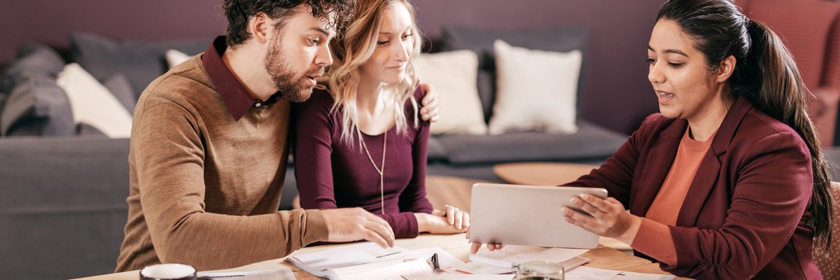 Young couple meets with professional woman.