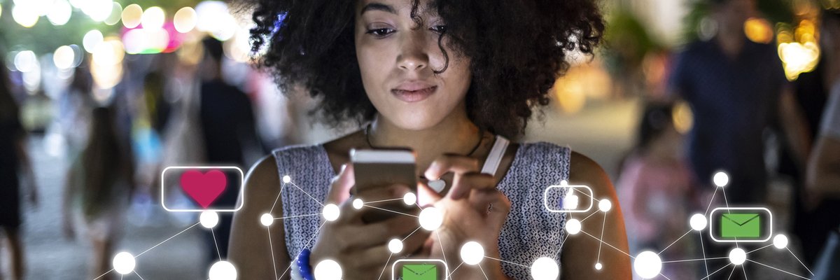 A young woman uses her phone to explore social media.