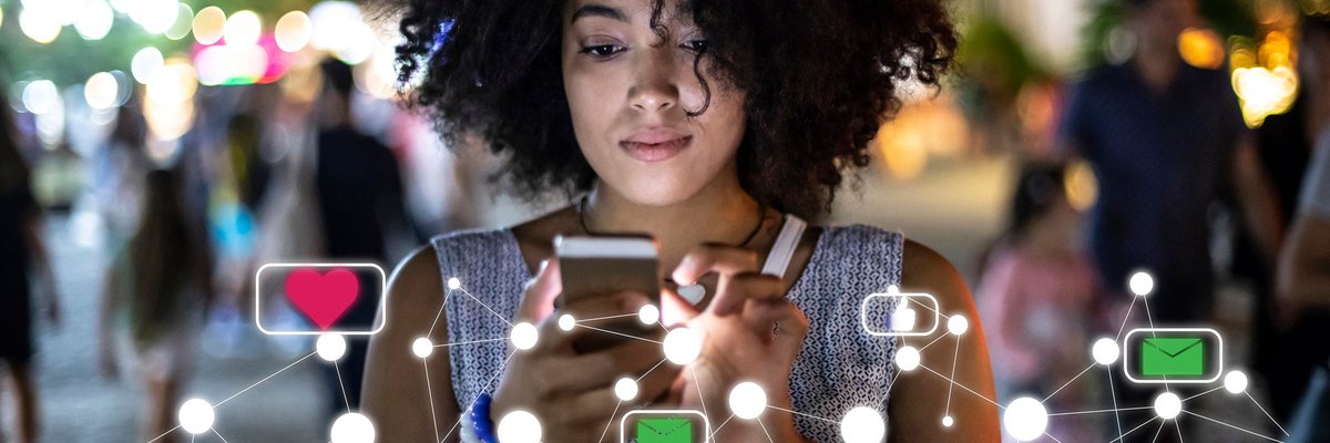 A young woman uses her phone to explore social media.