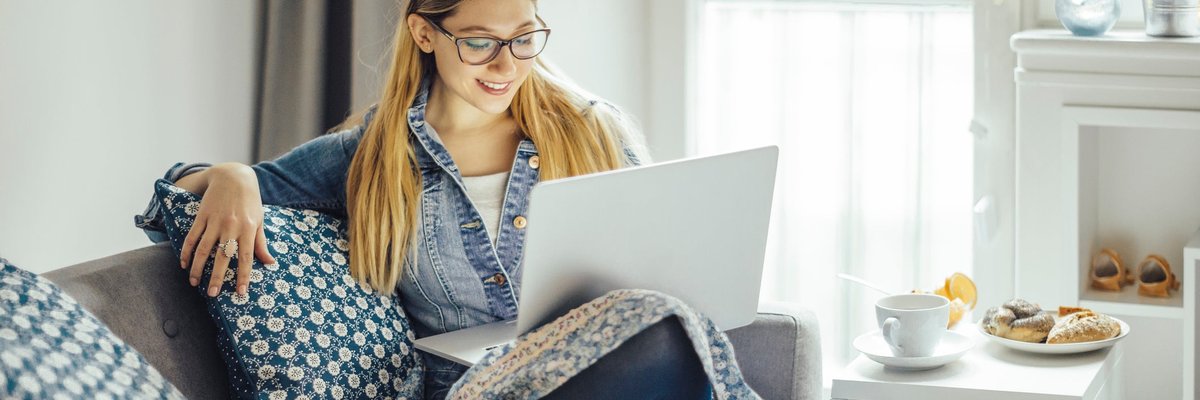 Young woman using laptop on the couch