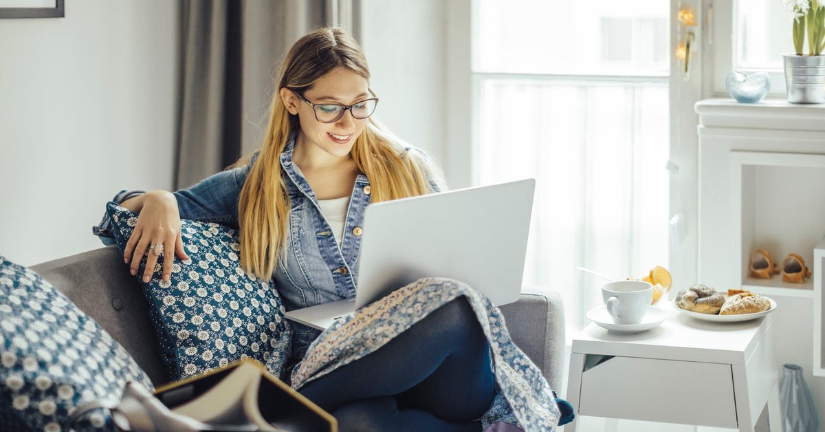 Young woman using laptop on the couch
