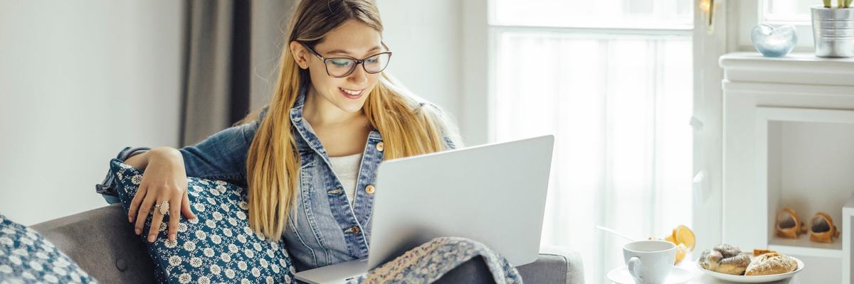 Young woman using laptop on the couch