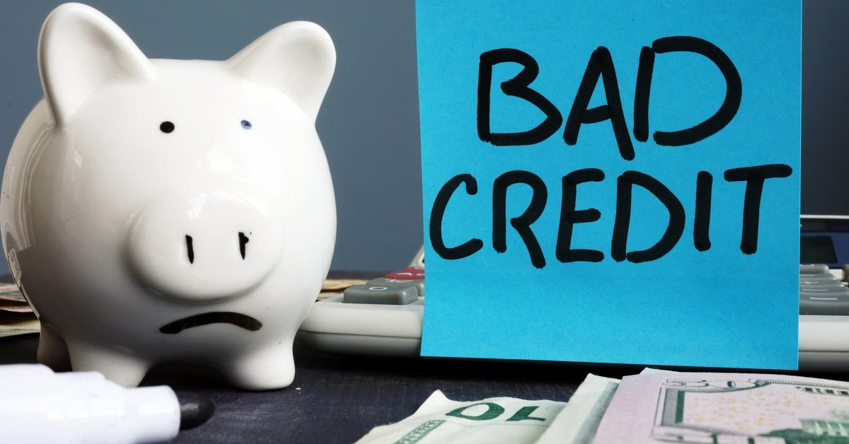 Piggy bank next to a sign that says "bad credit"