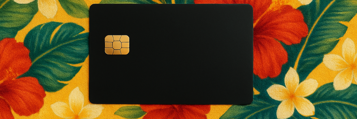 A black credit card against tropical floral background.