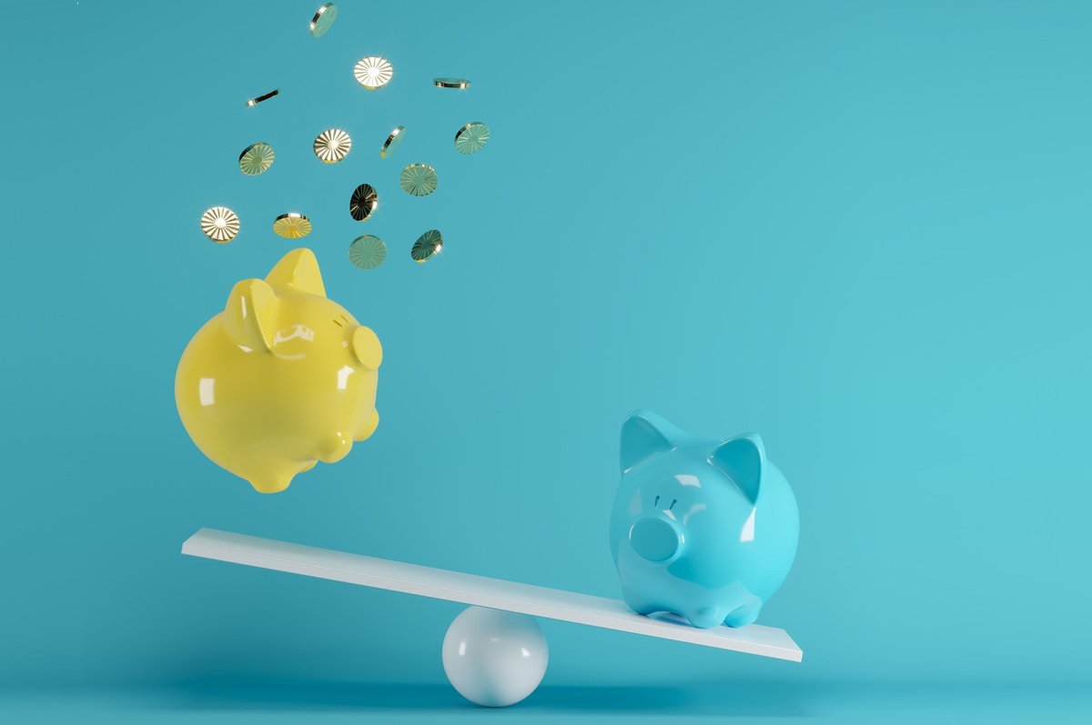 blue piggy bank sending yellow piggy bank flying off a seesaw.