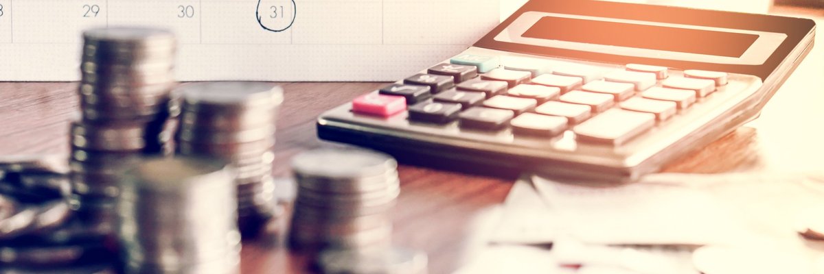 calendar, calculator, and money on table