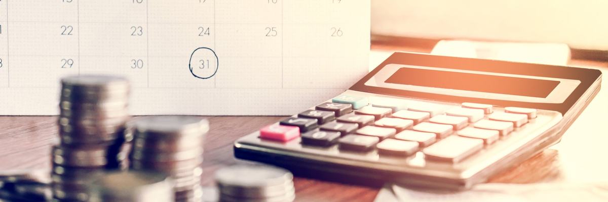 calendar, calculator, and money on table