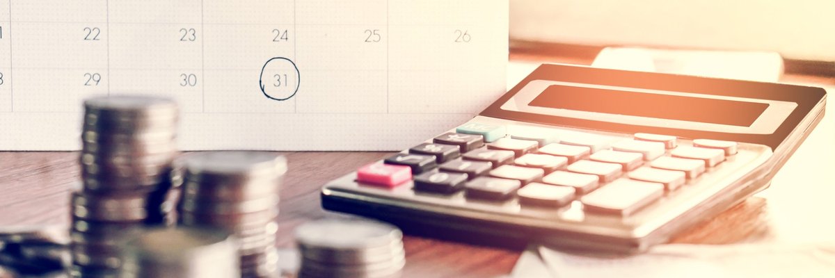 calendar, calculator, and money on table