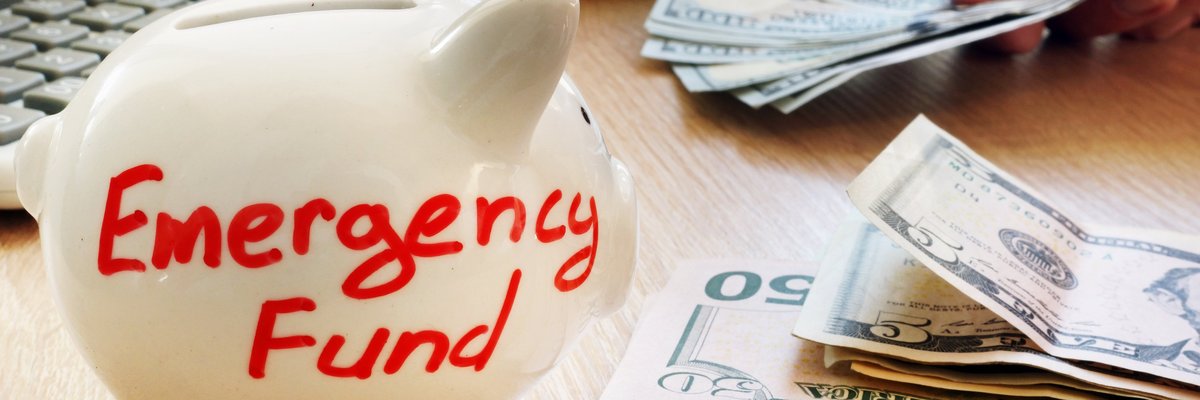 Piggy bank with "emergency fund" written on it