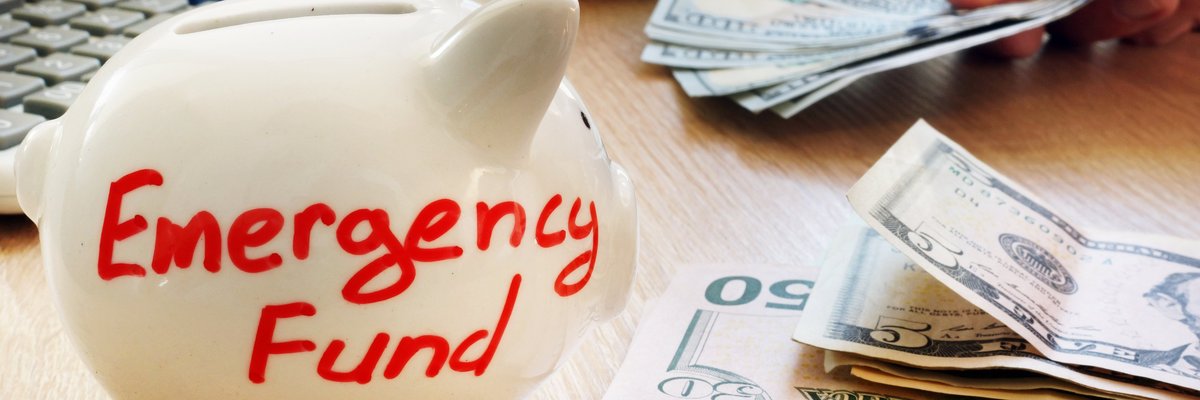 Piggy bank with "emergency fund" written on it