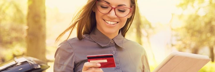 A smiling woman with a credit card.