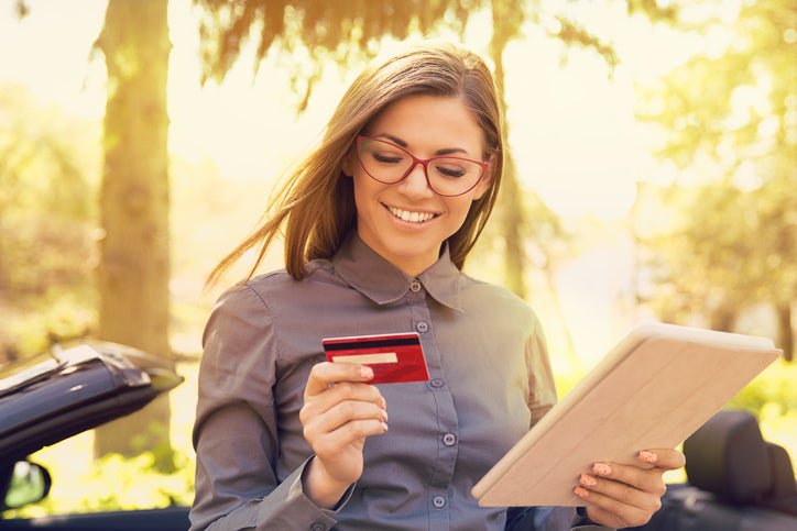 A smiling woman with a credit card.