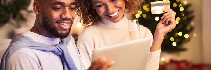 A couple shops online with a credit card during the holiday season