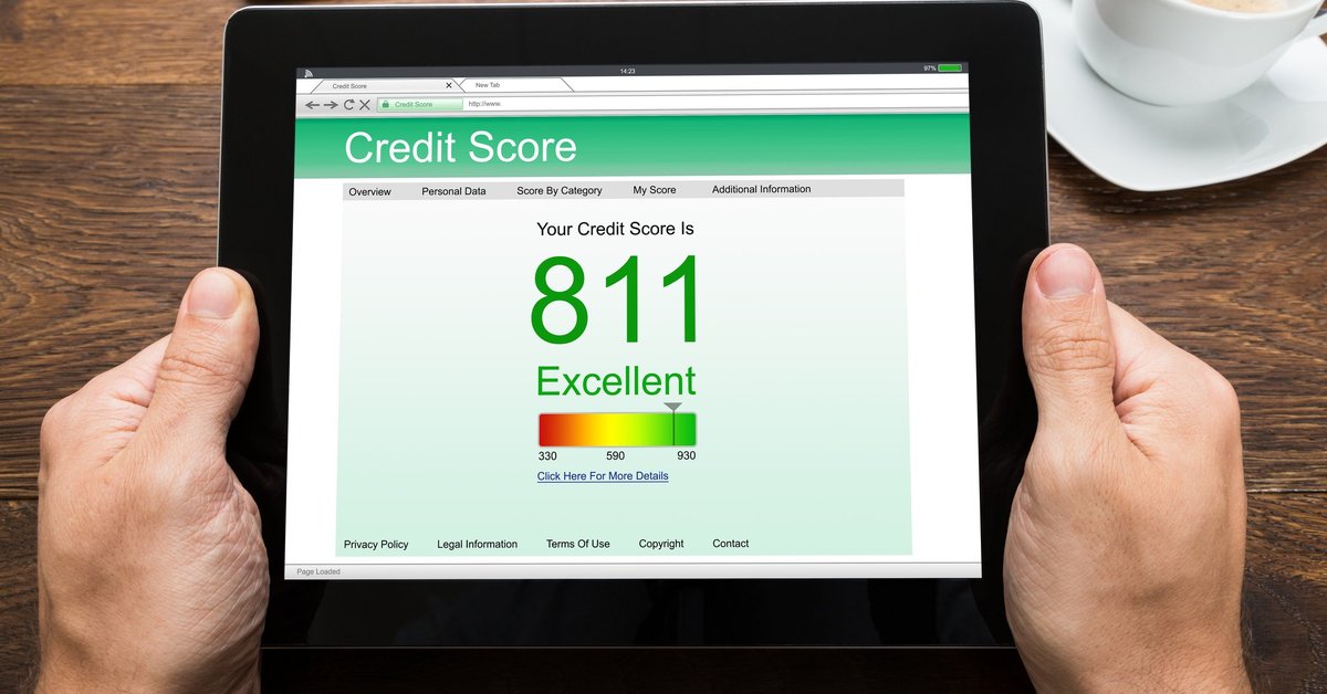 man holding a tablet with a screen that shows a credit score of 811