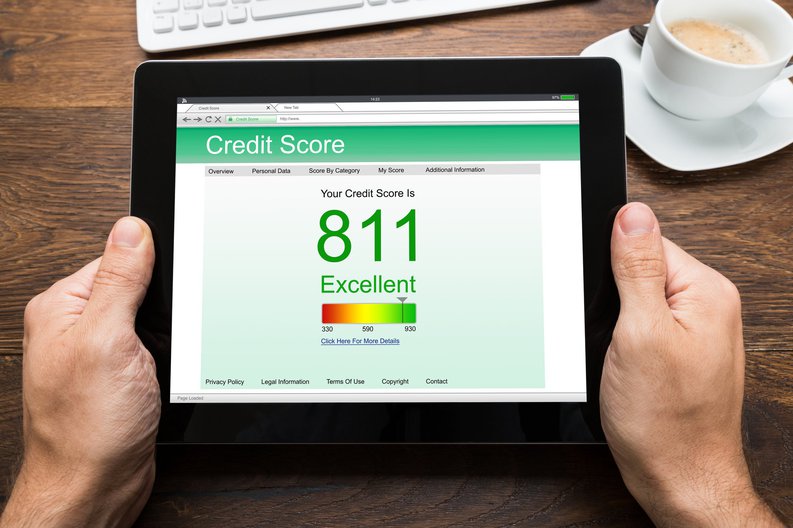 Hands holding a tablet displaying a credit score of 811