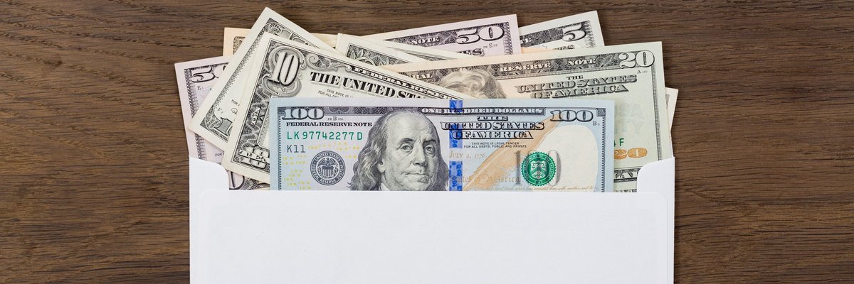 An envelope with various bills sticking out