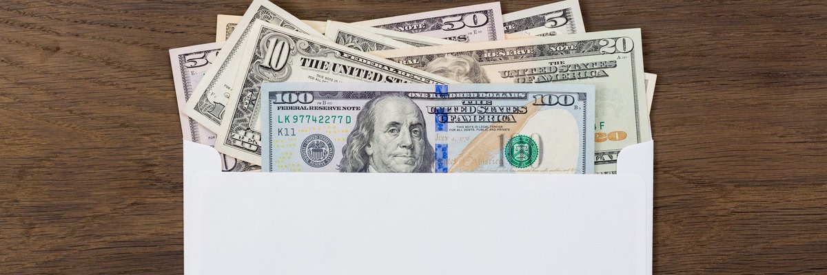 An envelope with various bills sticking out