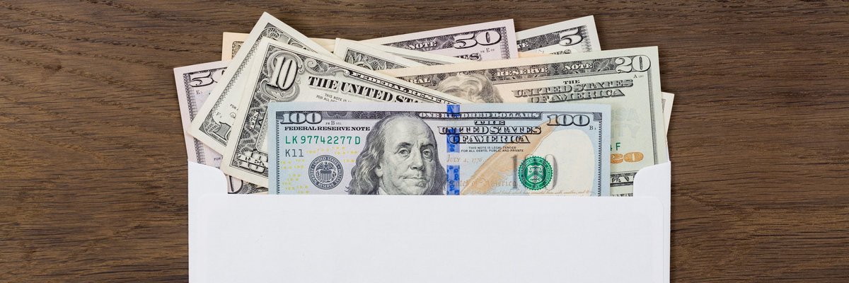 An envelope with various bills sticking out