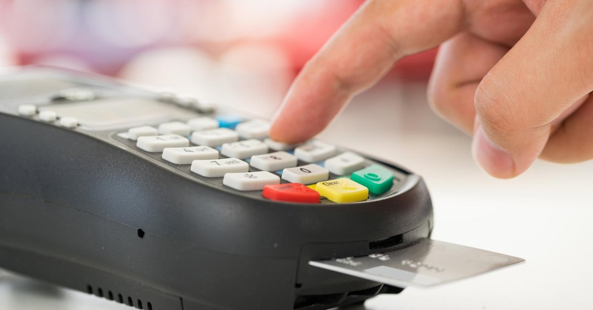 finger typing number into credit card reader
