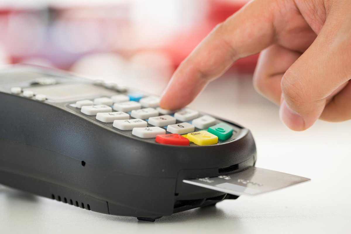 finger typing number into credit card reader