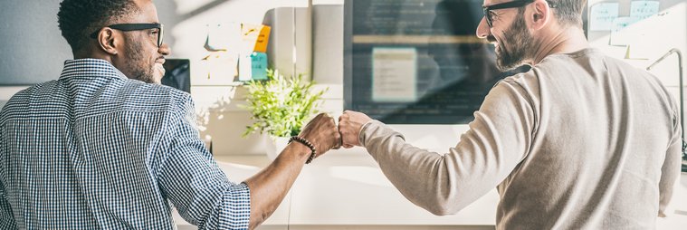 Two men doing a fist bump.