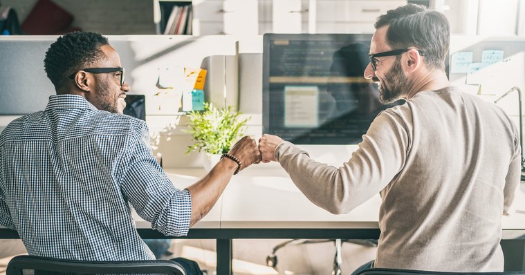 Two men doing a fist bump.