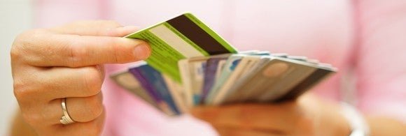 Close-up on woman's hands holding several credit cards