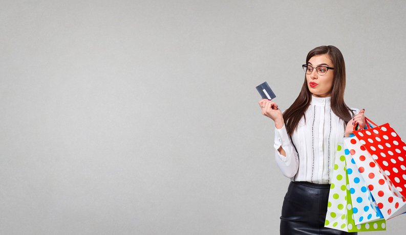 girl with credit card and shopping bags
