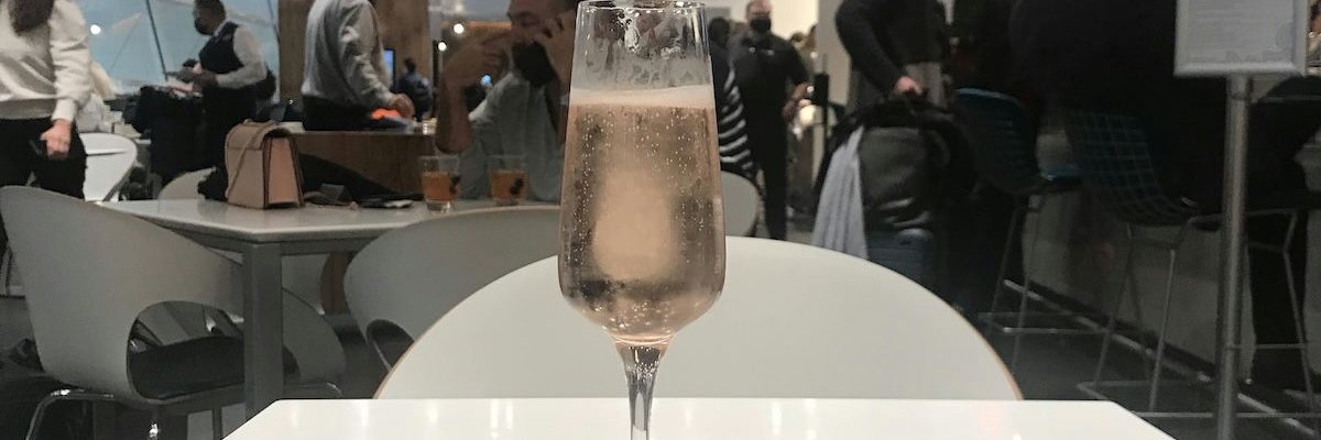 A glass of champagne in an airport lounge.