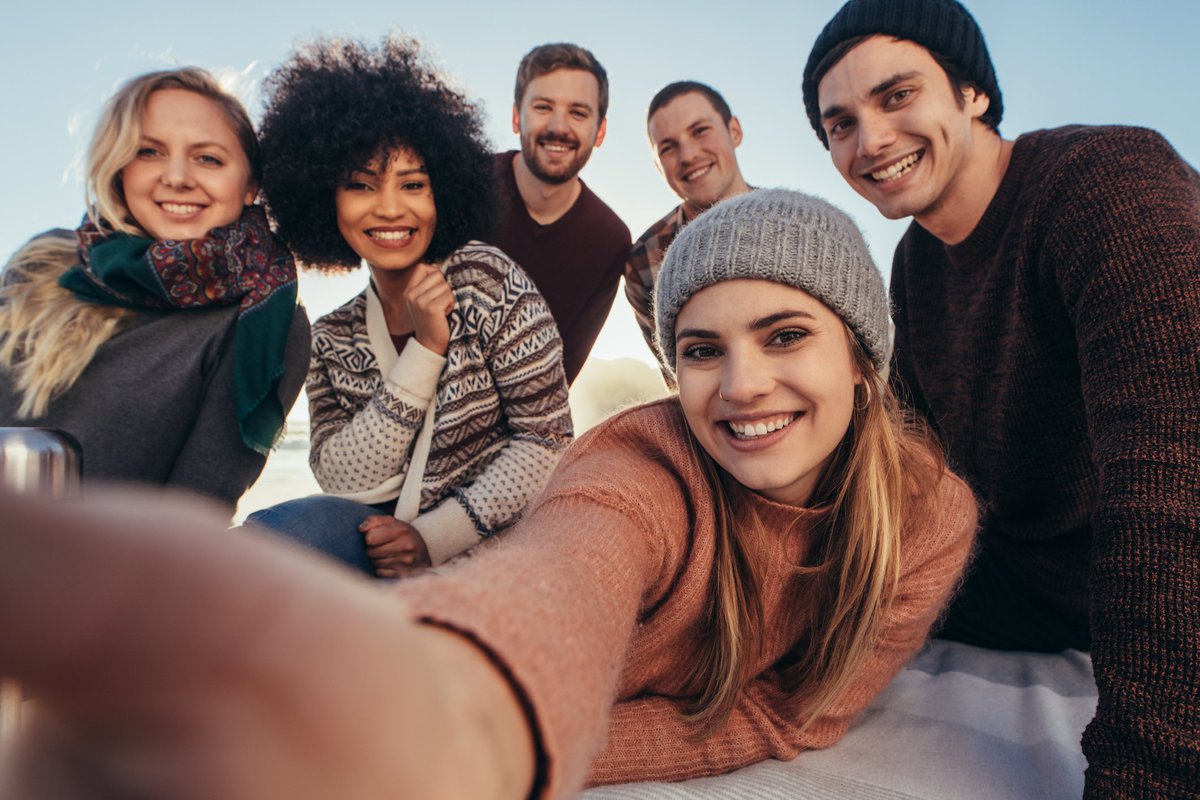 Group of young people smiling into camera