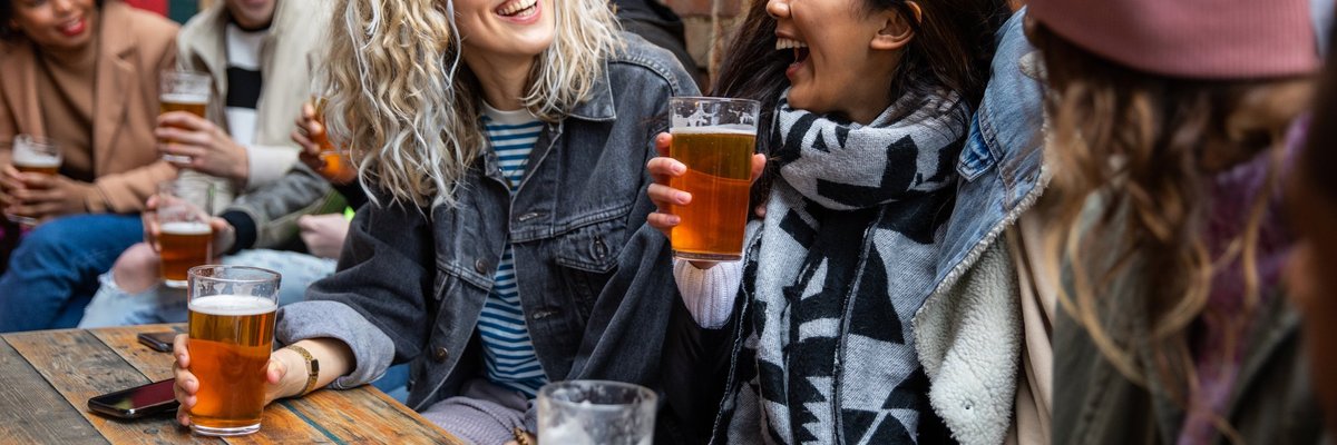 A group of friends drinking beer at a pub.