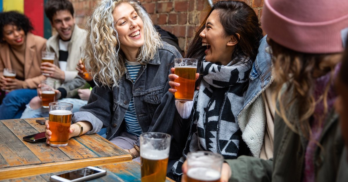 A group of friends drinking beer at a pub.