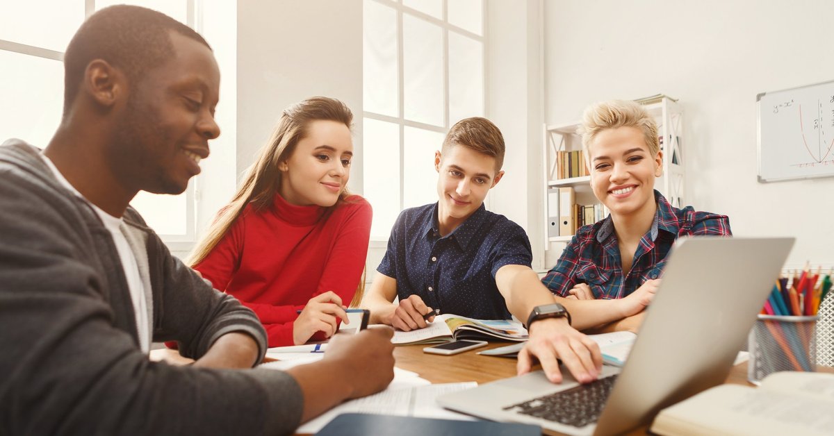 Group of teens around a laptop