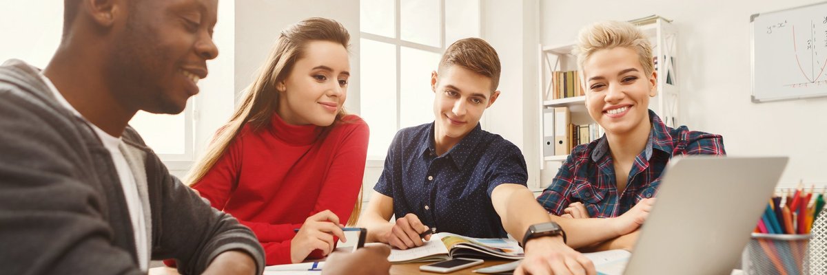Group of teens around a laptop