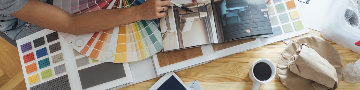 A couple looks over paint colors and a home decor magazine.