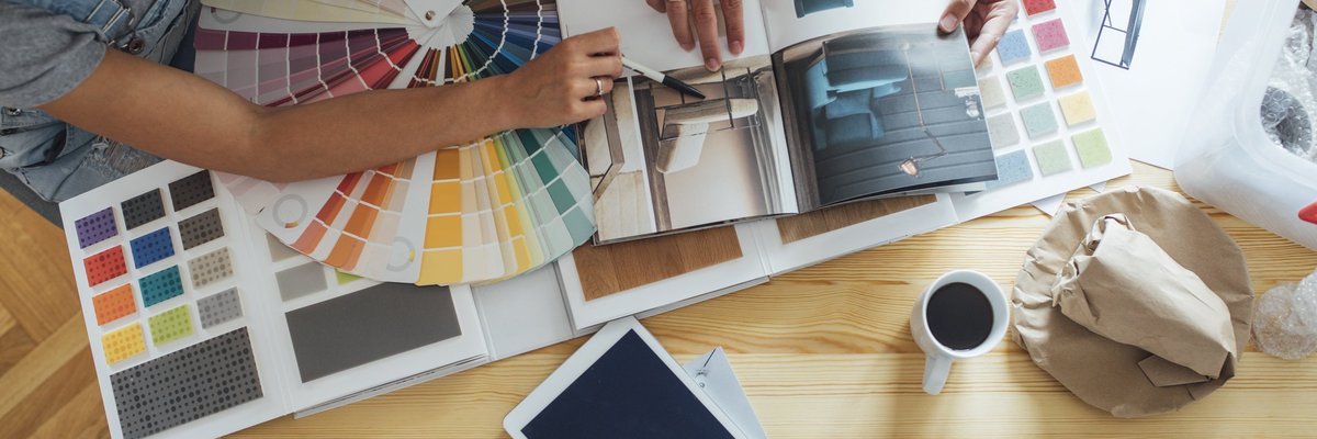 A couple looks over paint colors and a home decor magazine.