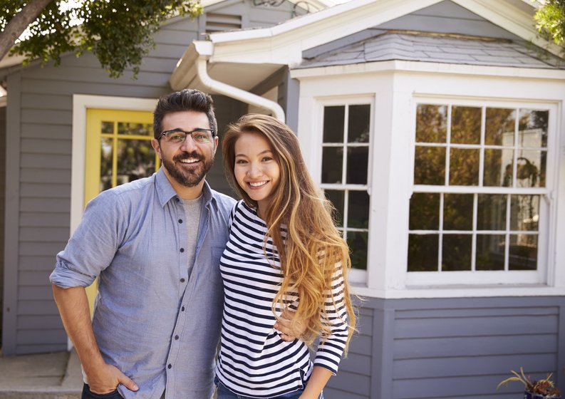 Home with a couple standing in front of it