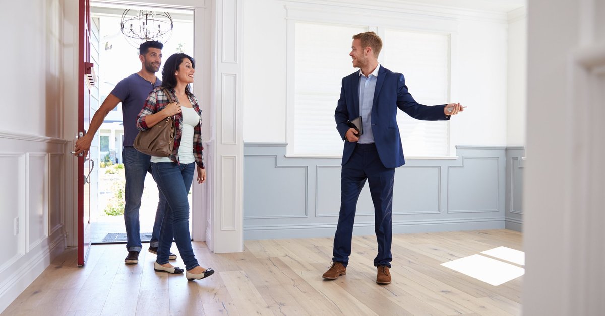 A couple looking at a home with a realtor.