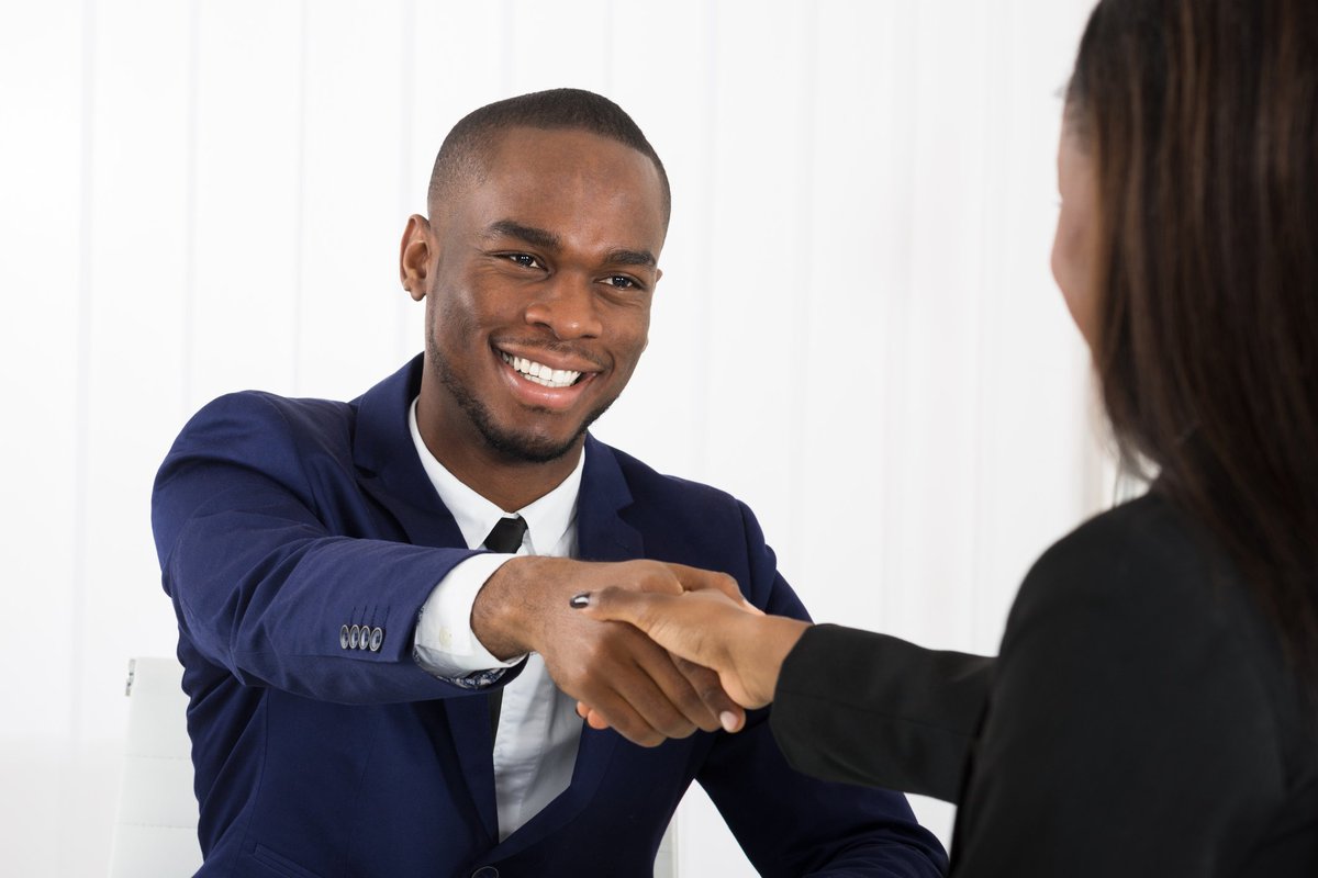 Man in suit shaking hands with woman