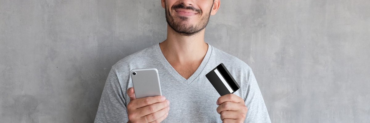 Man with credit card and cell phone