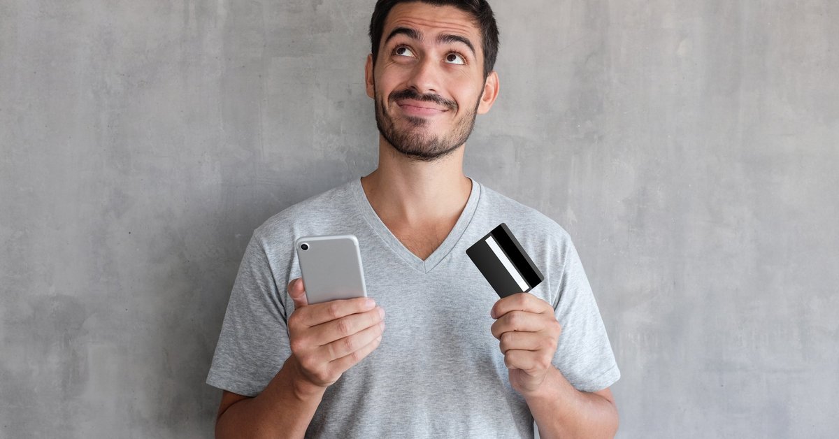 Man with credit card and cell phone