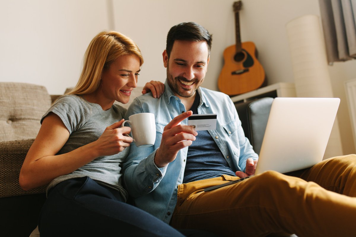 man and woman shopping with credit card online