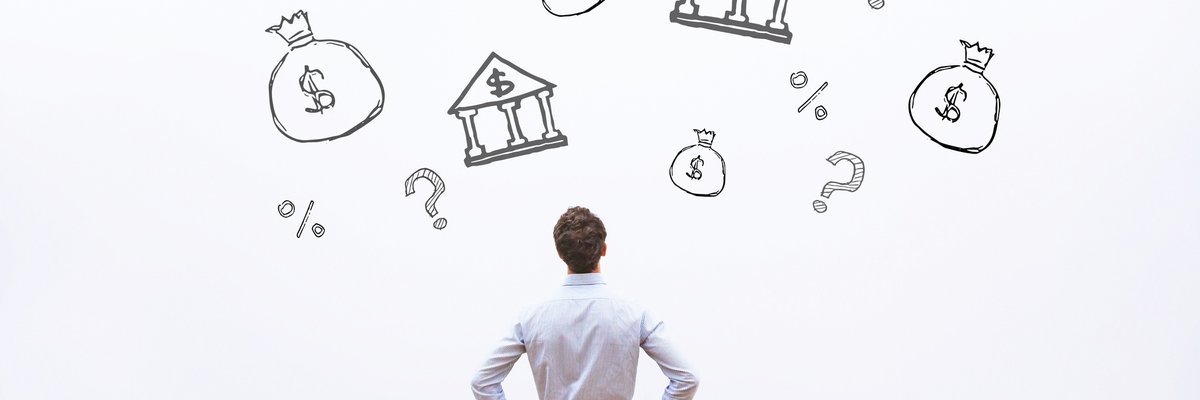 man looking at investment banking icons on wall