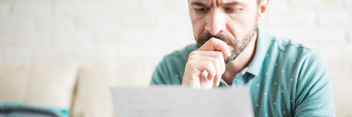 man looking at paper