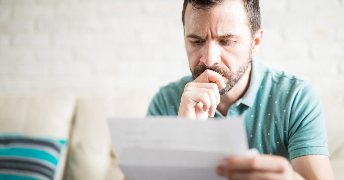 man looking at paper