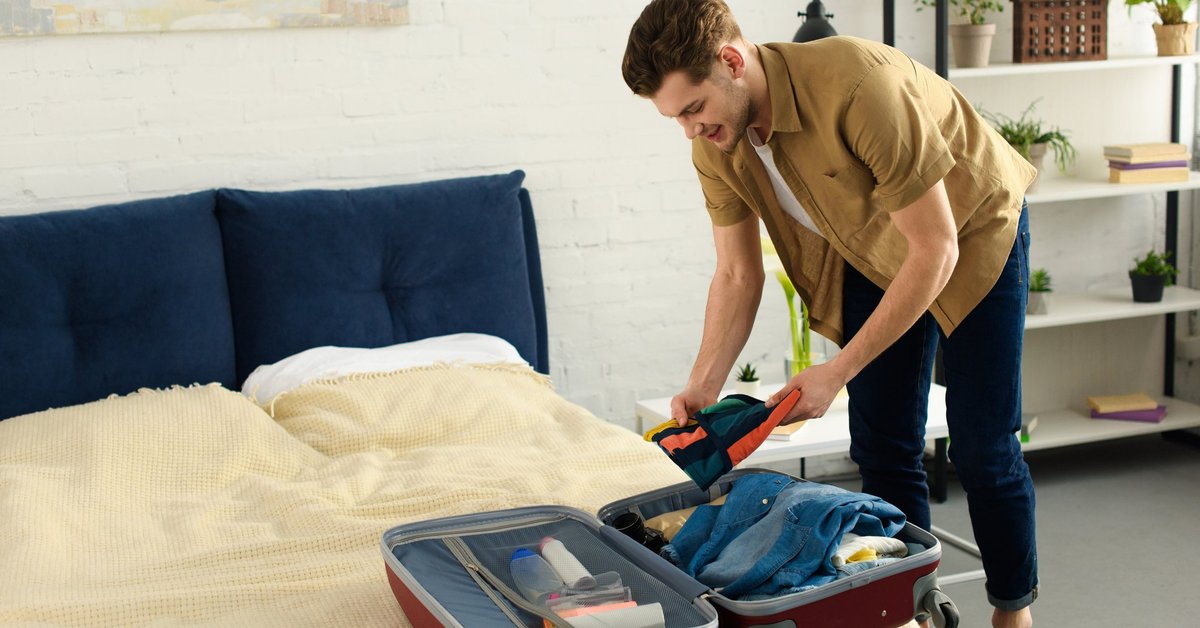 Man packing suitcase