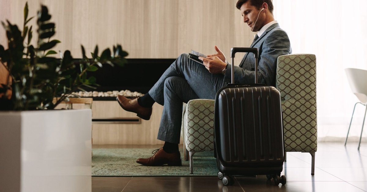 man relaxing in airport lounge